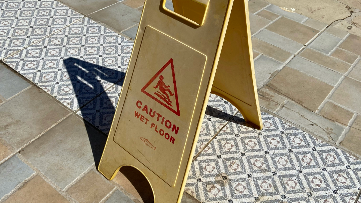 caution wet floor sign on tile floor